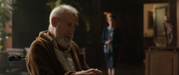 Movie still from “Jurassic World: Fallen Kingdom” (2018), directed by J.A. Bayona – An older man sitting in front of a woman; Medium shot, Over the shoulder angle