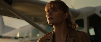 Movie still from “Jurassic World: Fallen Kingdom” (2018), directed by J.A. Bayona – A person wearing a brown jacket; Close Up shot, Low angle