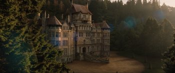 Movie still from “Jurassic World: Fallen Kingdom” (2018), directed by J.A. Bayona – An old building with a staircase going up the side of it; Extreme Wide shot, High angle