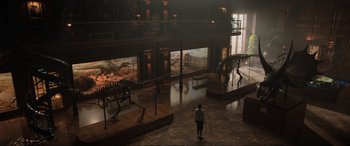 Movie still from “Jurassic World: Fallen Kingdom” (2018), directed by J.A. Bayona – A woman is standing in front of a display in a museum; Extreme Wide shot, High angle