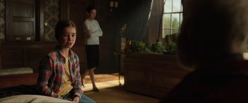 Movie still from “Jurassic World: Fallen Kingdom” (2018), directed by J.A. Bayona – Two young people are in a room with plants; Medium shot, Over the shoulder angle