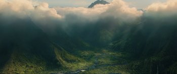 Movie still from “Jurassic World: Fallen Kingdom” (2018), directed by J.A. Bayona – A view of a lush green valley with a mountain in the background; Extreme Wide shot, High angle