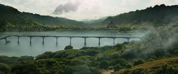 Movie still from “Jurassic World: Fallen Kingdom” (2018), directed by J.A. Bayona – An aerial view of a bridge over a river; Extreme Wide shot, High angle