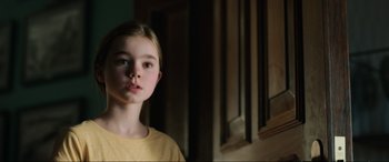 Movie still from “Jurassic World: Fallen Kingdom” (2018), directed by J.A. Bayona – A young girl in a yellow shirt looking at the camera; Close Up shot, Low angle