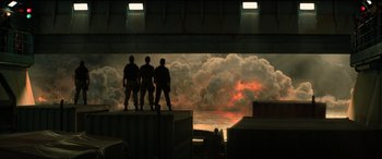 Movie still from “Jurassic World: Fallen Kingdom” (2018), directed by J.A. Bayona – Three men standing in front of a body of water; Extreme Wide shot, Low angle