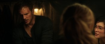 Movie still from “Jurassic World: Fallen Kingdom” (2018), directed by J.A. Bayona – A man sitting in front of a woman in a dark room; Close Up shot, Over the shoulder angle