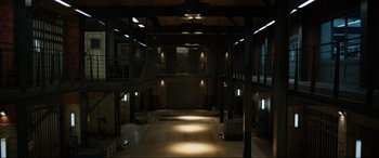 Movie still from “Jurassic World: Fallen Kingdom” (2018), directed by J.A. Bayona – An empty warehouse with lights shining on the ceiling; Extreme Wide shot, High angle