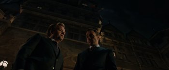 Movie still from “Jurassic World: Fallen Kingdom” (2018), directed by J.A. Bayona – A couple of men standing next to each other; Medium shot, Low angle