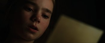 Movie still from “Jurassic World: Fallen Kingdom” (2018), directed by J.A. Bayona – A child looking at a book; Close Up shot, Low angle