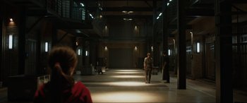 Movie still from “Jurassic World: Fallen Kingdom” (2018), directed by J.A. Bayona – Two people are standing in an empty building; Extreme Wide shot, Low angle