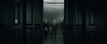 Movie still from “Jurassic World: Fallen Kingdom” (2018), directed by J.A. Bayona – A man in a suit and tie in an elevator; Wide shot, Low angle