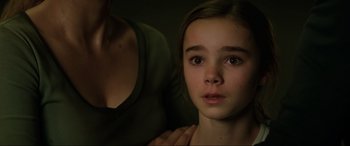 Movie still from “Jurassic World: Fallen Kingdom” (2018), directed by J.A. Bayona – A young girl with her hands on her chest; Close Up shot, High angle
