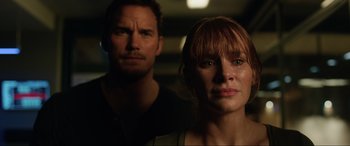 Movie still from “Jurassic World: Fallen Kingdom” (2018), directed by J.A. Bayona – A man and a woman standing next to each other in the dark; Close Up shot, Over the shoulder angle