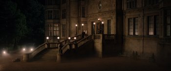 Movie still from “Jurassic World: Fallen Kingdom” (2018), directed by J.A. Bayona – Two people walking down a staircase at night time; Extreme Wide shot, High angle