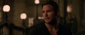 Movie still from “Jurassic World: Fallen Kingdom” (2018), directed by J.A. Bayona – A person wearing a black shirt; Close Up shot, Over the shoulder angle