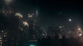 Movie still from “Justice League” (2017), directed by Zack Snyder – A city skyline at night with a helicopter in the sky; Extreme Wide shot, High angle