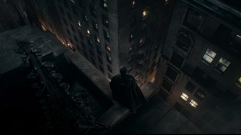 Movie still from “Justice League” (2017), directed by Zack Snyder – A man standing on the side of a tall building at night; Extreme Wide shot, Overhead angle