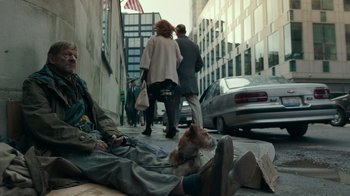 Movie still from “Justice League” (2017), directed by Zack Snyder – A dog sitting on the ground next to a person; Wide shot, High angle