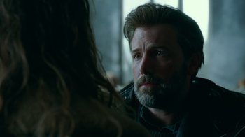 Movie still from “Justice League” (2017), directed by Zack Snyder – A man with long hair and a goatee looking at a woman; Close Up shot, Over the shoulder angle