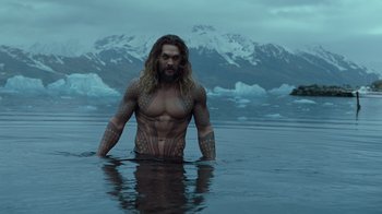 Movie still from “Justice League” (2017), directed by Zack Snyder – A man in a body of water with mountains in the background; Medium shot, Low angle