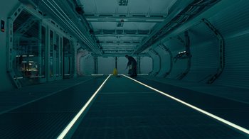 Movie still from “Justice League” (2017), directed by Zack Snyder – A person is standing in a dark room; Extreme Wide shot, High angle