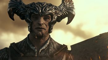 Movie still from “Justice League” (2017), directed by Zack Snyder – A person wearing a helmet with horns; Close Up shot, Low angle