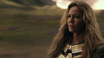 Movie still from “Justice League” (2017), directed by Zack Snyder – A person with long hair wearing a costume; Close Up shot, Over the shoulder angle