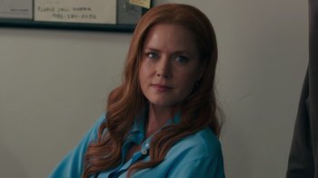 Movie still from “Justice League” (2017), directed by Zack Snyder – A person with long red hair; Close Up shot, Over the shoulder angle