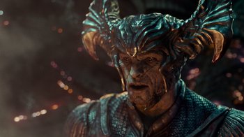 Movie still from “Justice League” (2017), directed by Zack Snyder – A man's face in a costume; Close Up shot, Over the shoulder angle