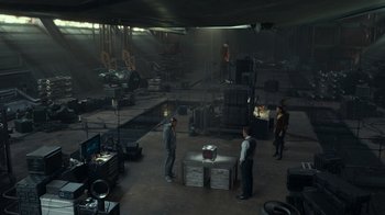 Movie still from “Justice League” (2017), directed by Zack Snyder – A group of men standing around in a room; Extreme Wide shot, High angle