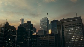 Movie still from “Justice League” (2017), directed by Zack Snyder – A helicopter flying over a city skyline at sunset; Extreme Wide shot, High angle