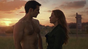 Movie still from “Justice League” (2017), directed by Zack Snyder – A man and a woman standing next to each other in a field; Medium shot, Over the shoulder angle