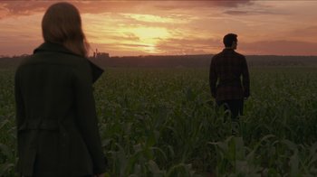 Movie still from “Justice League” (2017), directed by Zack Snyder – A man and a woman standing in a field at sunset; Wide shot, Over the shoulder angle