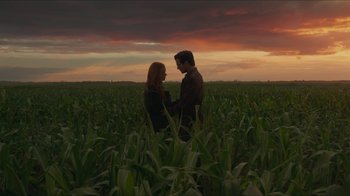 Movie still from “Justice League” (2017), directed by Zack Snyder – A man and a woman holding hands in a corn field; Extreme Wide shot, Low angle