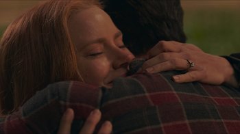 Movie still from “Justice League” (2017), directed by Zack Snyder – A person holding a pillow; Close Up shot, Over the shoulder angle