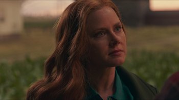 Movie still from “Justice League” (2017), directed by Zack Snyder – A person with long red hair; Close Up shot, Over the shoulder angle