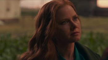 Movie still from “Justice League” (2017), directed by Zack Snyder – A person with long red hair; Close Up shot, Over the shoulder angle