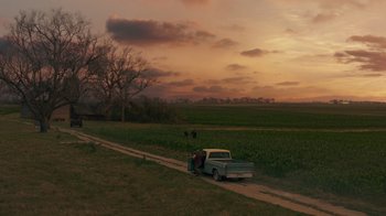 Movie still from “Justice League” (2017), directed by Zack Snyder – An old pick - up truck parked on the side of the road; Extreme Wide shot, High angle