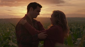 Movie still from “Justice League” (2017), directed by Zack Snyder – A man and a woman embracing in front of a sunset; Medium shot, Over the shoulder angle