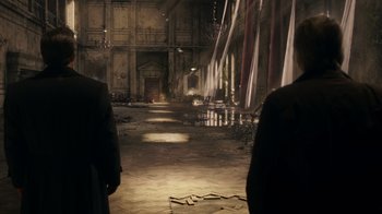 Movie still from “Justice League” (2017), directed by Zack Snyder – Two men are standing in an abandoned building; Wide shot, High angle