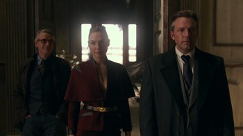 Movie still from “Justice League” (2017), directed by Zack Snyder – A man and a woman standing next to each other in a room; Medium shot, Low angle