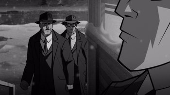 Movie still from “Justice League: Warworld” (2023), directed by Jeff Wamester – A black and white image of two men in suits and hats; Medium shot, Over the shoulder angle