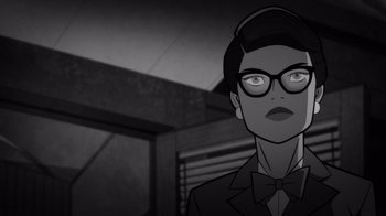 Movie still from “Justice League: Warworld” (2023), directed by Jeff Wamester – A black and white image of a woman with glasses; Close Up shot, Over the shoulder angle