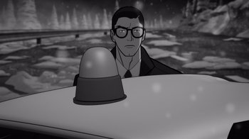 Movie still from “Justice League: Warworld” (2023), directed by Jeff Wamester – A man with glasses is sitting in the back of a police car; Medium shot, Over the shoulder angle