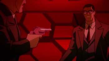 Movie still from “Justice League: Warworld” (2023), directed by Jeff Wamester – A man holding a gun pointed at another man in a red room; Close Up shot, Over the shoulder angle