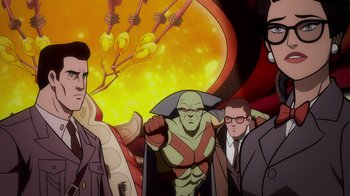 Movie still from “Justice League: Warworld” (2023), directed by Jeff Wamester – A group of men standing next to each other in front of an image; Medium shot, High angle