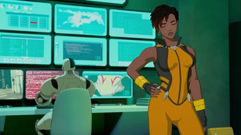 Movie still from “Justice League x RWBY: Super Heroes and Huntsmen Part Two” (2023), directed by Yssa Badiola – An animated woman is standing in front of computer screens; Medium shot, Over the shoulder angle