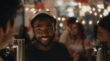 Movie still from “Atlanta” (2016), created by Donald Glover – A person wearing a hat; Close Up shot, Over the shoulder angle