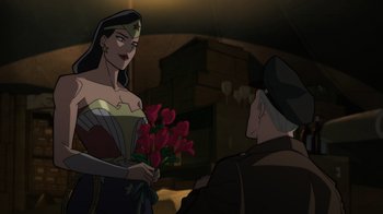 Movie still from “Justice Society: World War II” (2021), directed by Jeff Wamester – A woman holding a bunch of roses in front of an older man; Medium shot, Over the shoulder angle