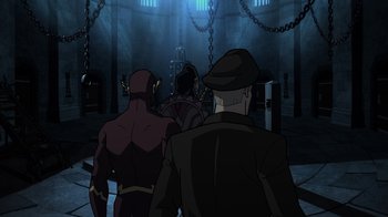 Movie still from “Justice Society: World War II” (2021), directed by Jeff Wamester – A group of people walking in a dark room; Wide shot, Over the shoulder angle